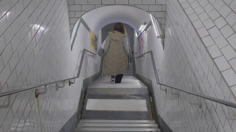Walking down stairs in Paris subway, capturing an urban atmosphere of movement Stock Footage 305473665
