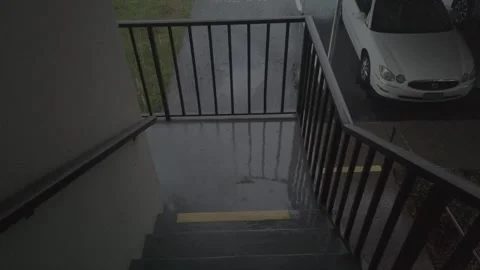 Walking down stairs with the rain falling Stock Footage 241631282