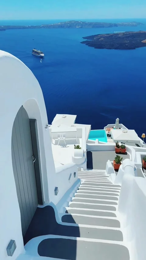 Walking down the stairs with view to luxurious apartments and the Caldera. Stock Footage 334010361