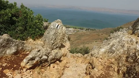 Walking Down Steep Path of Mountain Toward Sea Stock Footage 77810677