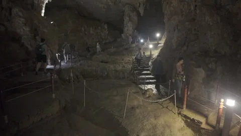 Walking down steps in a cave at ha long bay Stock Footage 287211766
