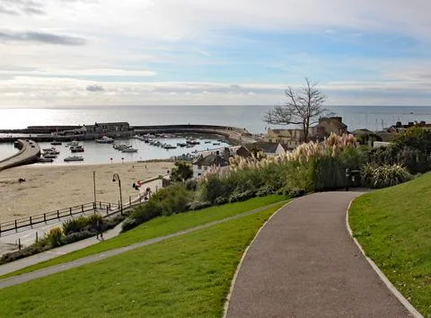 Walking down through the park to the Cobb at Lyme Regis in Dorset, England. Stock Photos