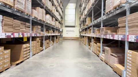 Walking Down Warehouse Aisle With Stacked Flat-Pack Boxes Stock Footage 319981603