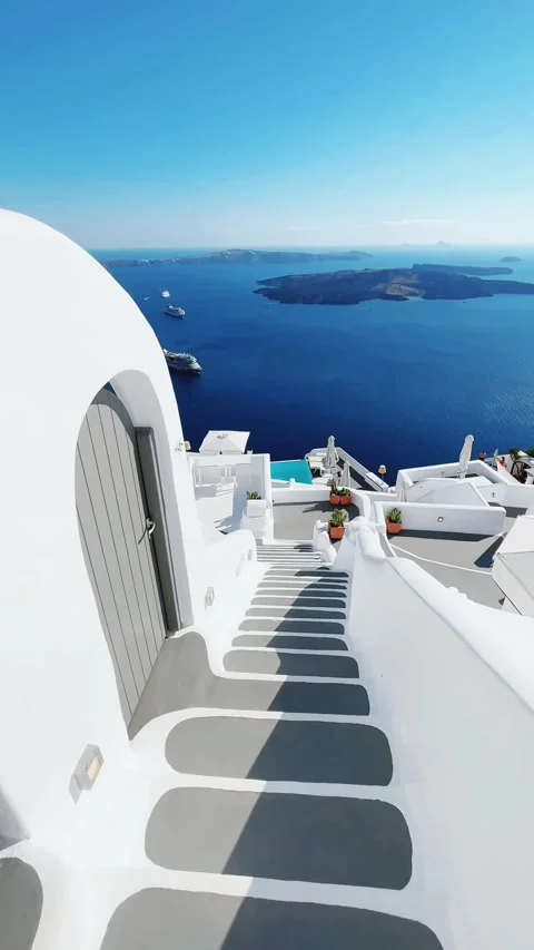 Walking down whitewashed stairs in Santorini with view to the Caldera. Vídeos de archivo 334010378