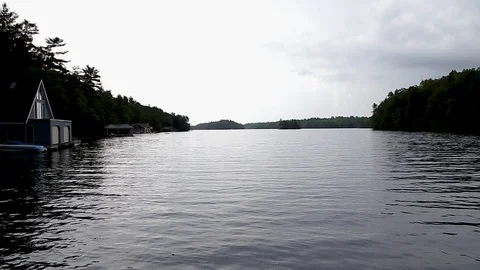 Walking down a wood dock looking onto Lake Joseph, Ontario. Stock Footage 96542484