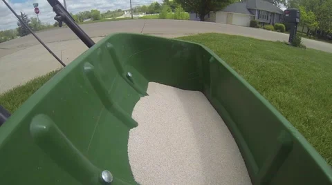 Walking a Drop Seeder Over Lawn - Weed Killer and Fertilizer Stock Footage