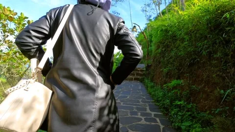 Walking on the edge of a green high hill with clear sky Stock Footage 165480163