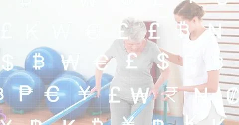 Walking elder patient gray set on parallel bars in gym caregiver white tunic Stock Photos