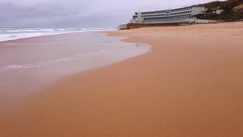 Walking in a Empty beach of in a stormy day with strong waves breaking Stock Footage 144023466