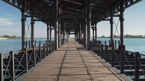 Walking on empty historical pier in Huelva Spain at sunset Stock Footage 277207878