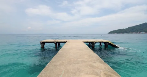 Walking to the end of old abandoned concrete pier, looking on turquoise waters Stock Footage 314636690