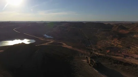 Walking excavator draws ore. Sunset. Bird's eye view Stock Footage 73429699