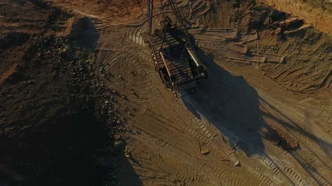 Walking excavator draws ore. Sunset. Bird's eye view Stock Footage 73430904