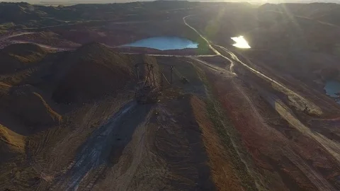 Walking excavator draws ore. Sunset. Bird's eye view Stock Footage 73479157
