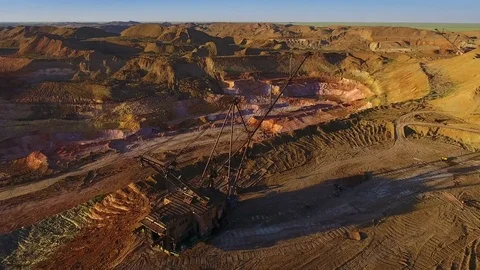 Walking excavator draws ore. Sunset. Bird's eye view Video stock 73590084