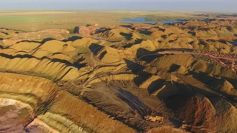 Walking excavator draws ore. Sunset. Bird's eye view Stockbeeldmateriaal 73590615