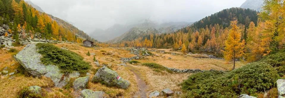 Walking at fall in a cloudy day in a mountain valley Stock Photos