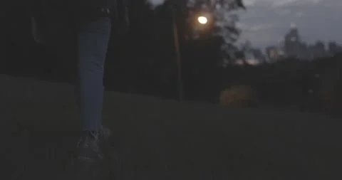 Walking in a field with city behind Stock Footage 140718378