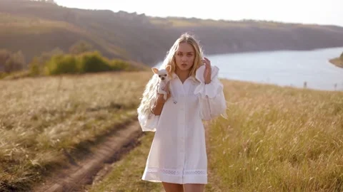 Walking in a field with an incredible view of the river Stock Footage 236559369