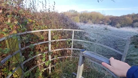Walking to a field opening a gate on a beautiful frosty day in autumn. Stock Footage 257933235