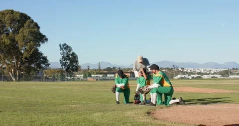 Walking onto field, senior coach and diverse baseball players responding to Stock Footage 340009103