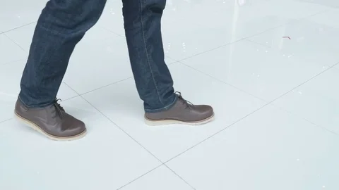 Walking on the floor, close-up view of man's leather shoes Stock Footage 77625997