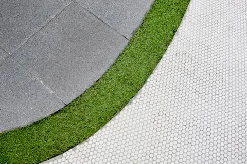 Walking foot path with green grass and tiles background texture Stock Photos