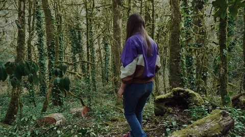 Walking in the forest, a girl has found the stump, went to it and sat down for 스톡 동영상 113774569