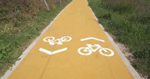 Walking forward along cycle path with white painted symbols Video stock 132013762