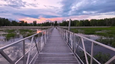 Walking Forward on Aluminum Floating Boardwalk at Sunset, Parc Plaisance, Quebec 動画素材 337419918