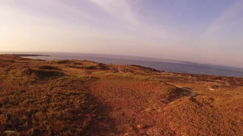 Walking forward to dry deserted sandy grass bush land at hillside with horizon o Stock Footage 240483240