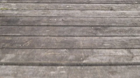 Walking forward over wooden decking, first person pov Stock Footage 132211475