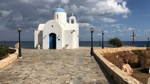 Walking front of a sea side Chapel on a Cloudy day Stock Footage 90651902
