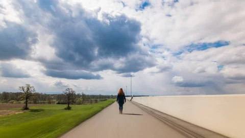 Walking girl hyperlapse with massive clouds Stock Footage 101745750
