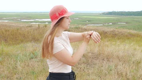 Walking girl using  pedometer on touchscreen display smartwatch outdoor Stock Footage 136749252