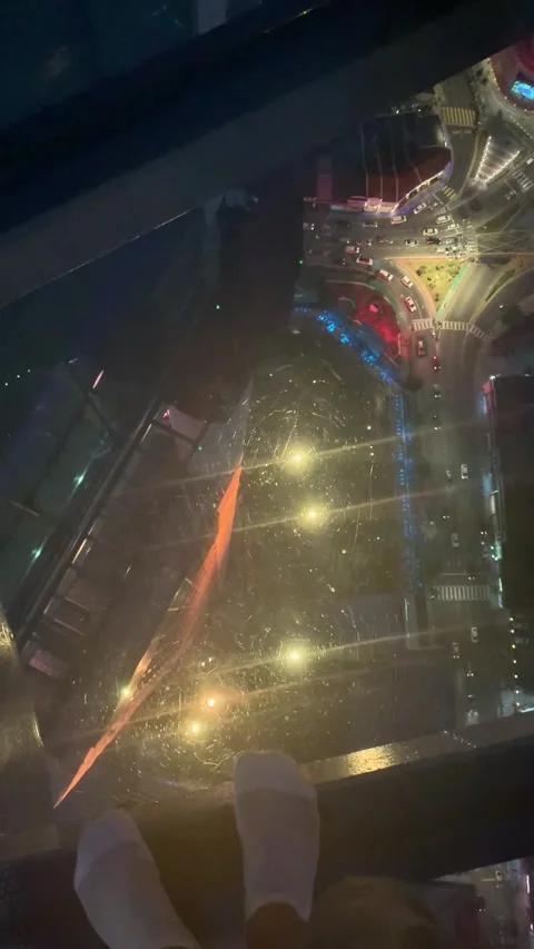 Walking on a glass floor over George Town by night Stock Footage 343557585