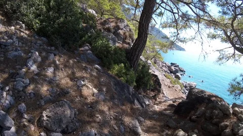 Walking with GoPro Camera on a rocky Path along the Sea Shore of Crete island Stock Footage 86428201