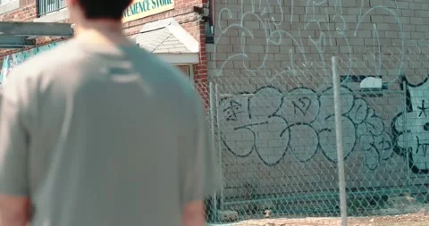 Walking by Graffiti Wall Stock Footage 193676231