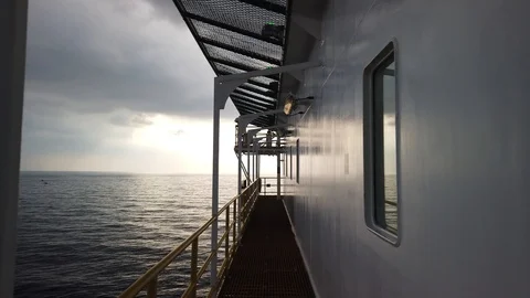 Walking on the grating beside an accommodation of a tender drilling rig Stock Footage 111162298
