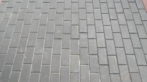 Walking on a gray tile of road, sight to down, sidewalk in motion, going forward Stock Footage 111441320