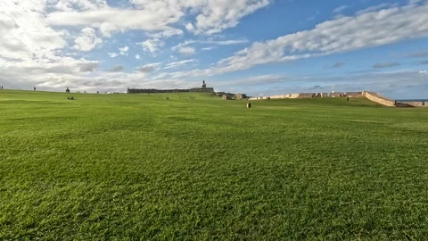 Walking green lawn in front castillo san felipe del morro san juan puerto rico Stock Footage 277469287