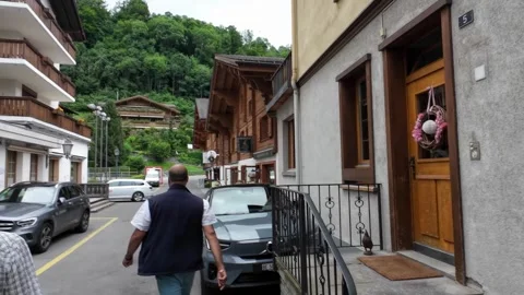 Walking Gstaad Side Street with Parked Cars and Chalets Stock Footage 340369231