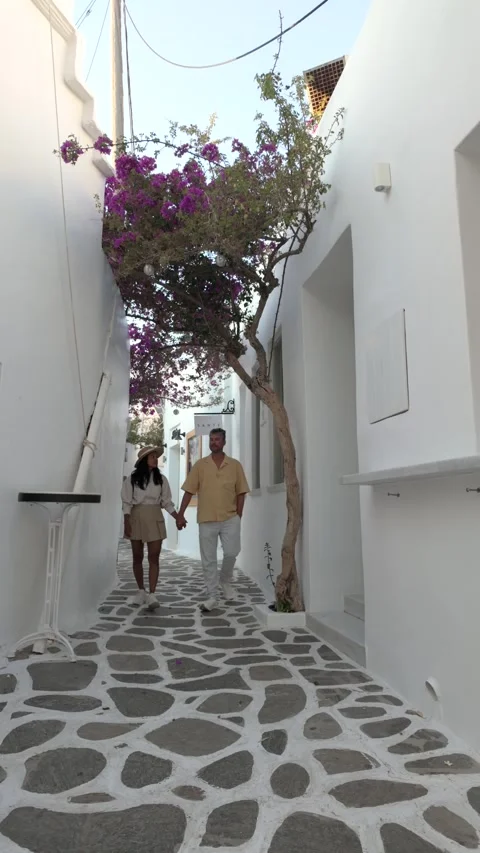 Walking hand in hand through the charming streets of paros, greece Stock Footage 337359134