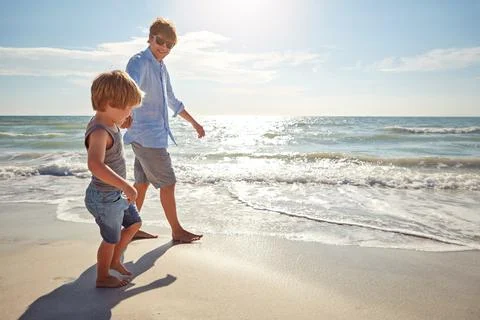 Walking in his fathers footsteps. a young man and his son enjoying a summer day Stock Photos