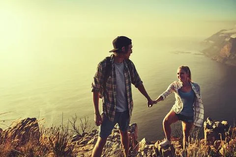 Walking, holding hands and help with couple in mountains for hike, exercise or Fotos de archivo