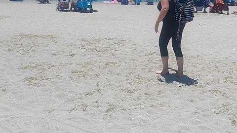 Walking on hot sand on the beach Stockbeeldmateriaal 156415730