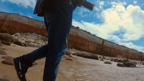 Walking by Hunstanton Cliffs with a camera Stock Footage 120114502