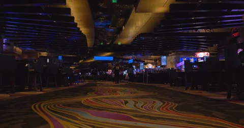 Walking inside Las Vegas casino while people playing slot machines 動画素材 147098505