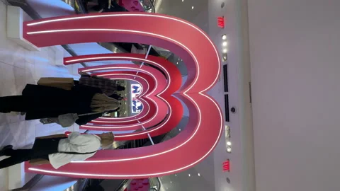 Walking inside Macy's store department along corridor decorated as a pink heart Stock Footage 233353151