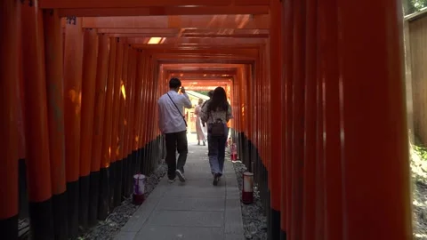 Walking inside of Many Vermilion Torii Gates at Fushimi Inari Temple in Kyoto Stock Footage 264985720